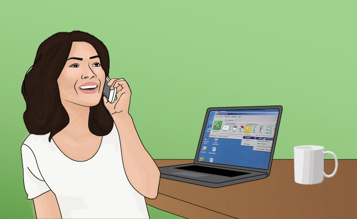 An image of Diana, woman in her 40's chatting on her cell phone and using her laptop computer with zoomtext